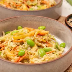 Frischer Chinakohlsalat asiatisch mit Edamame, Karottenstreifen und Sesam in einer Schüssel.