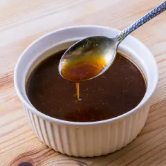 Eine Löffelprobe der dunklen Yakisoba-Sauce, die die Zutaten für ein köstliches Gericht andeutet.