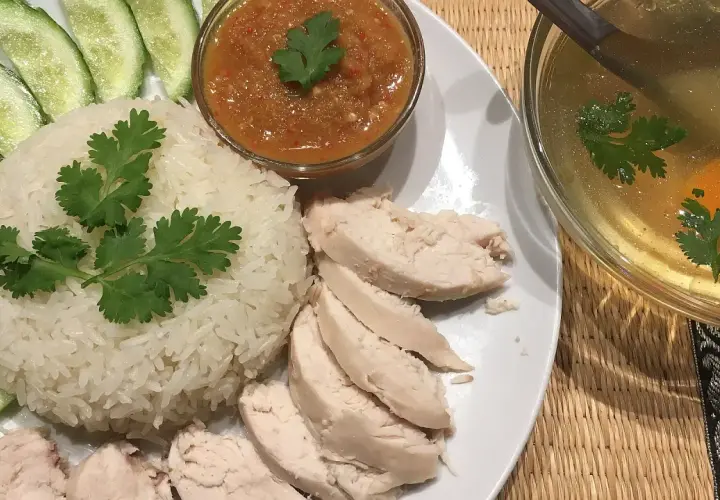 Khao man gai: Reis, Hähnchen, Gurkenscheiben, scharfe Sauce und eine klare Brühe mit Ei und Koriander.